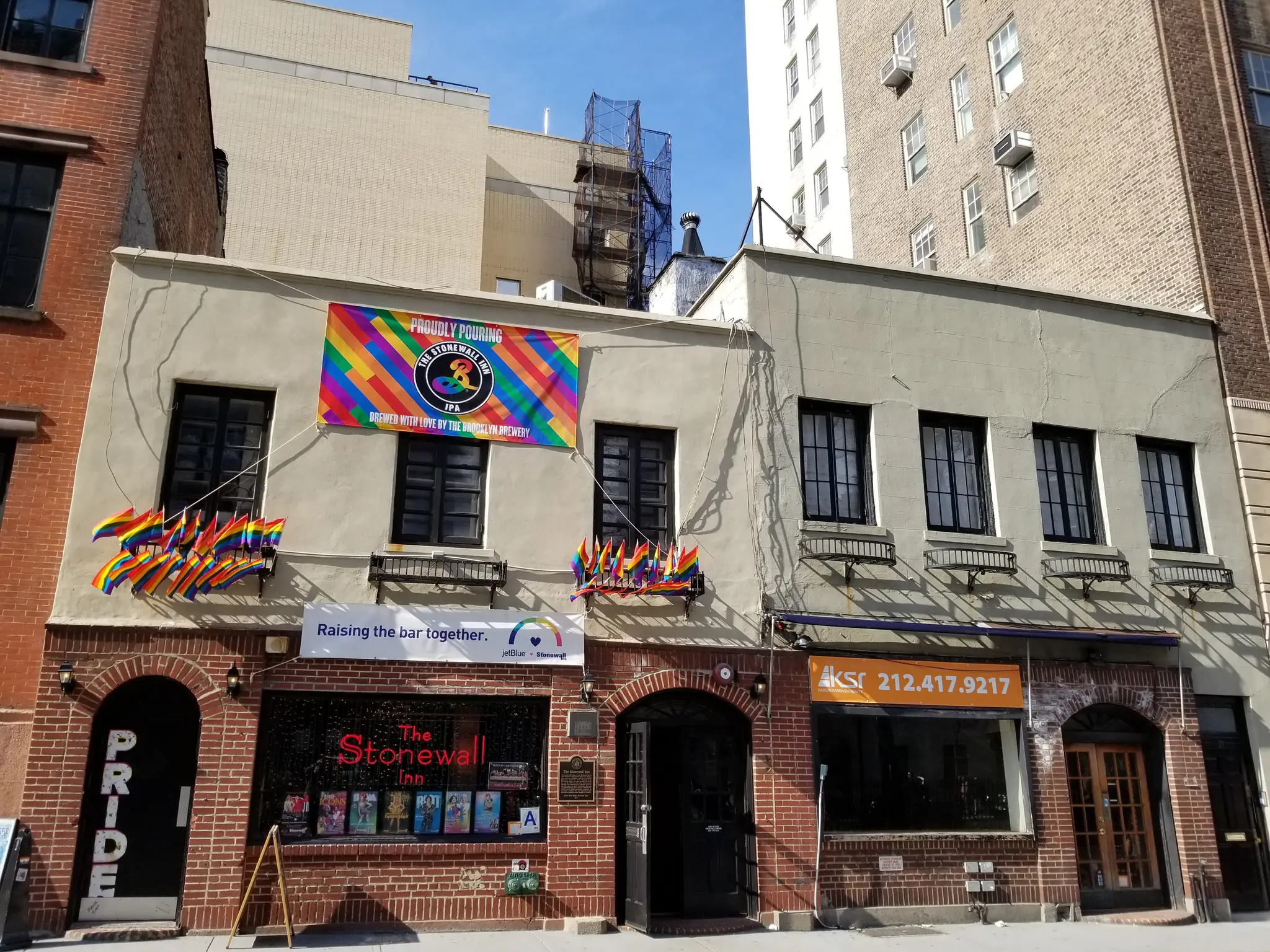 The Stonewall Inn on Christopher Street with Pride flags above the entrance