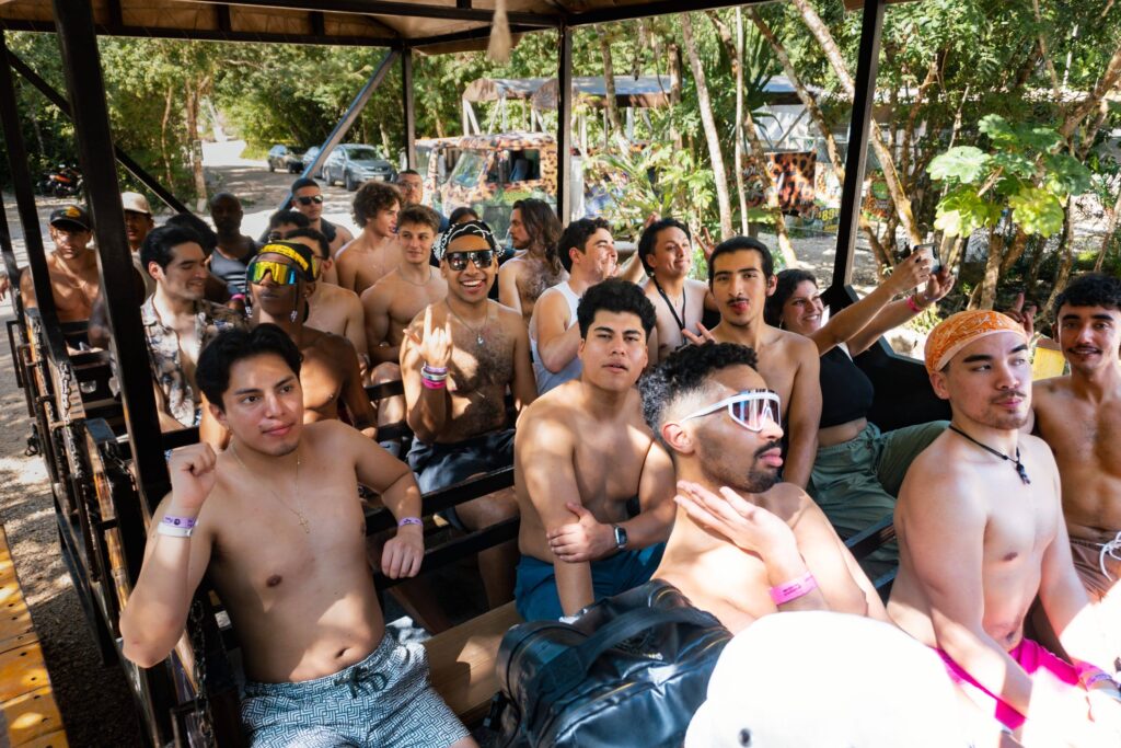 Retreat participants enjoying a group adventure in a tropical setting, riding together in an open-air vehicle
