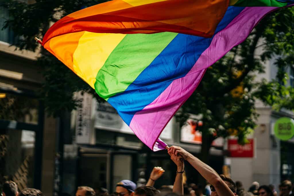 LGBTQ+ flag waving in crowd